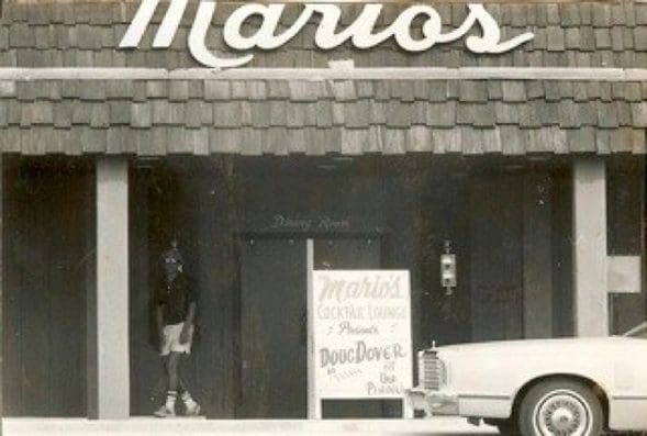 Mario's entrance with vintage car parked outside.