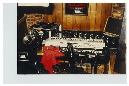 Home music studio with keyboards and audio equipment.