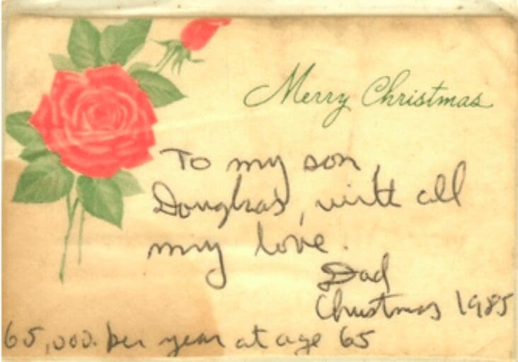 Handwritten Christmas note with a rose decoration.