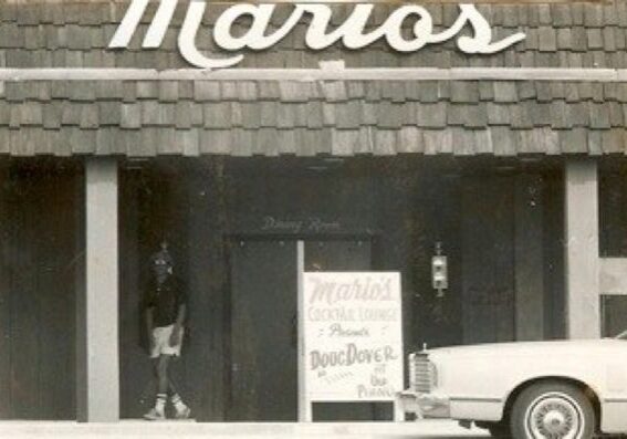 Mario's entrance with vintage car parked outside.