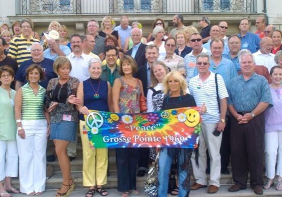 Group photo with a "Peace" banner.