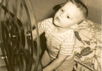 Child playing with a large spinning wheel.