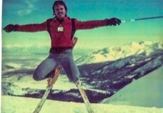 Skier jumping in snowy mountain landscape.
