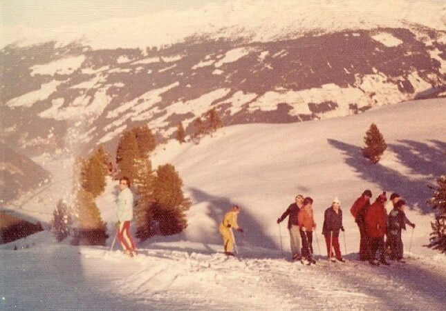 Group skiing on a snowy mountain slope.