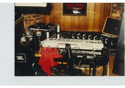 Home music studio with keyboards and audio equipment.